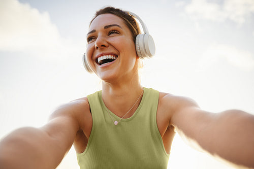 Fitness woman taking a fun selfie against the sky
