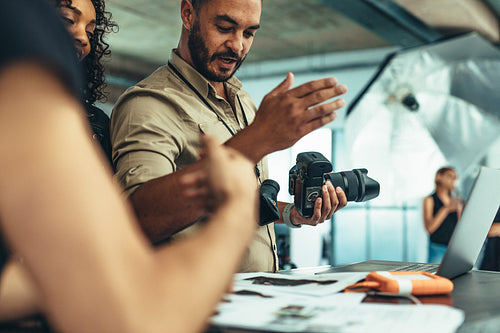 Photographer having a discussion with his team