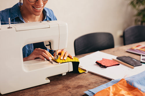 Woman hands sewing a face mask at home