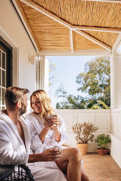 Married couple relaxing on a hotel balcony in the morning