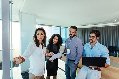 Business investors discussing business ideas in boardroom.