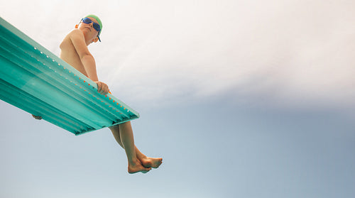 Boy on diving platform