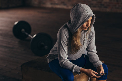 Woman taking break after workout at gym