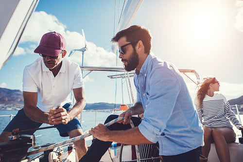 Men preparing to set sail on yacht
