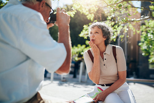 Beautiful senior woman blowing a kiss to camera
