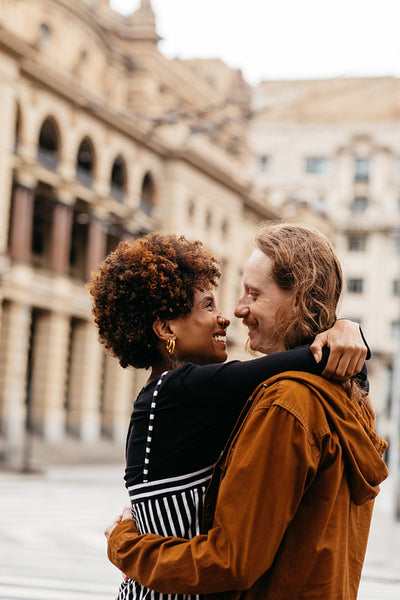 Embracing love and togetherness, couple enjoys city streets