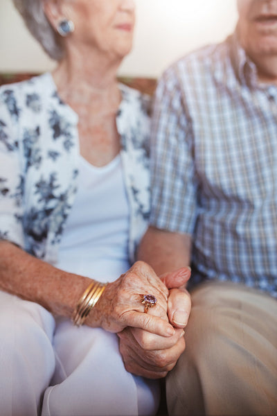 Senior couple holding hands