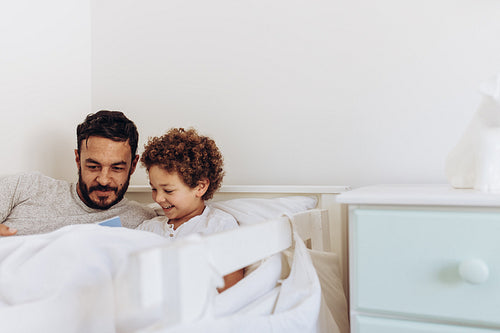 Father and son reading a book