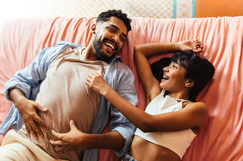 Father and daughter sharing a joyful moment on a comfortable couch at home