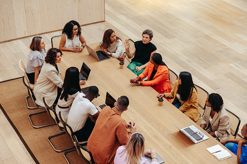 Overhead shot of diverse professionals engaging in a business strategy session