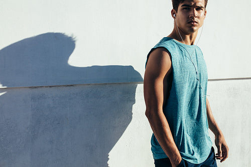 Fit male runner relaxing after workout