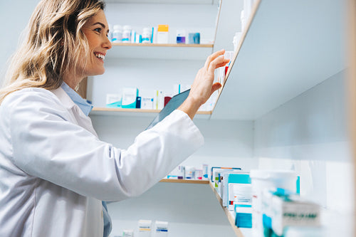 Female doctor getting medication in her pharmacy