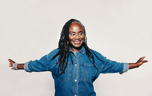 Happy mature woman looking away with a smile in a studio