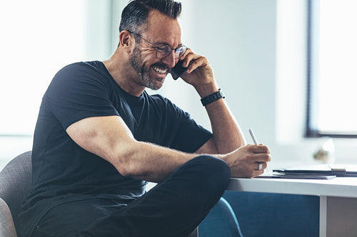 Mature businessman talking on cellphone