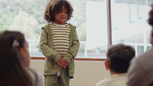 First day introductions at school: Young boy introducing himself to his new class on first day of elementary school