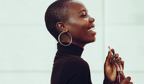 Cheerful woman with a cola