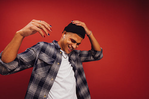 Cheerful young man enjoying his favourite music