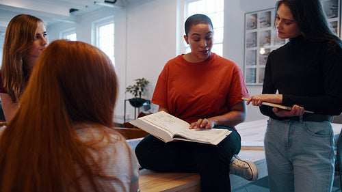 Group of girls studying together in college library