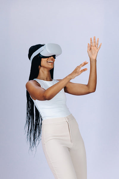 Happy young woman enjoying a virtual reality game