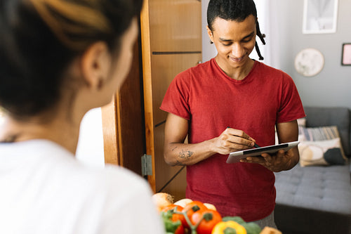 African American man receiving a grocery delivery at home