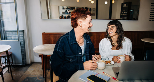 Friends enjoying coffee together at a cozy cafe