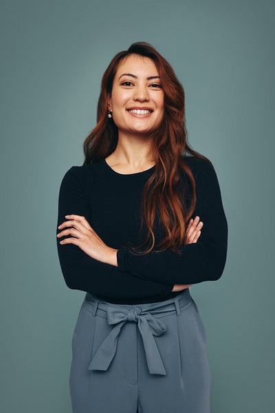 Young woman smiling at the camera in a studio