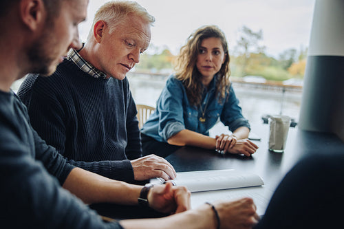 Businessman checking agreement document in the meeting