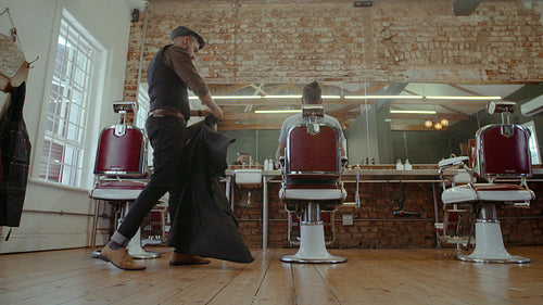 Barber serving client at salon