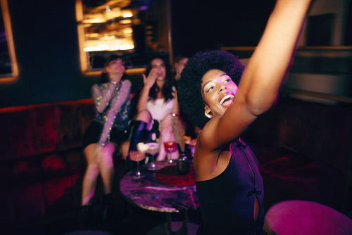 Young women enjoying a night out together at a stylish modern venue