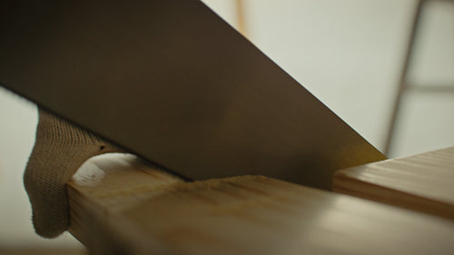 Hands-on work: Man cuts wood in preparation for home updates