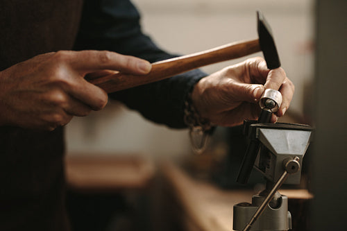 Jewelry designer shaping a ring at her workshop