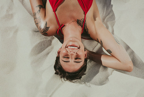 Close up of woman relaxing on beach sand