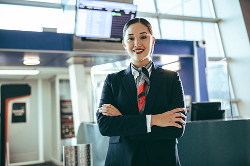 Confident flight attendant at international airport