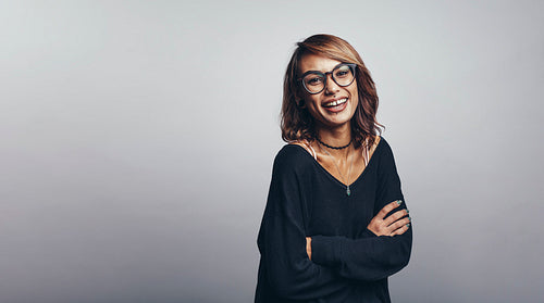 Smiling woman standing with arms crossed