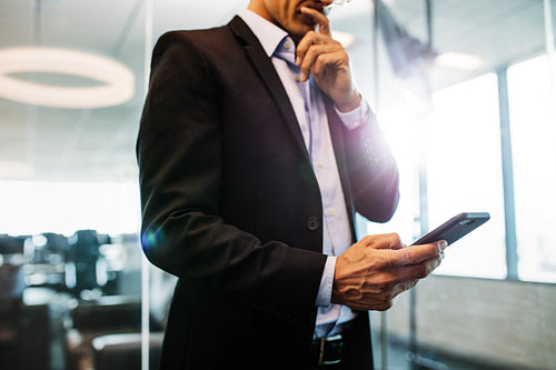 Businessman using mobile phone in office