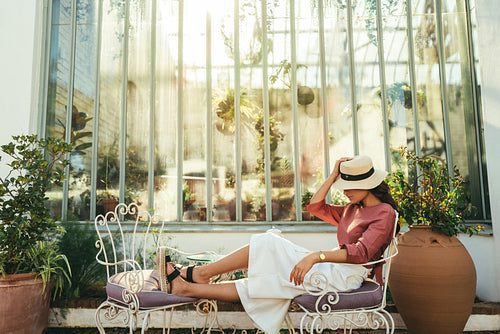 Elegant young woman relaxing outside a hotel