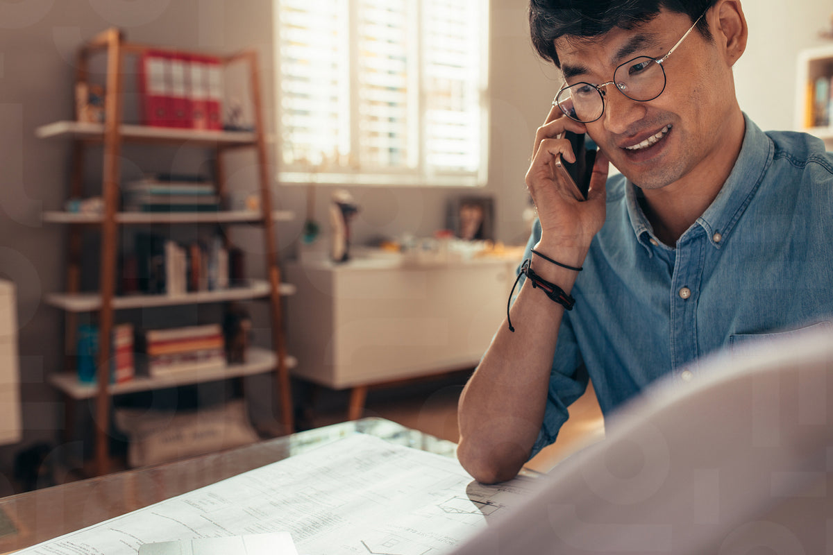 Architect with plan answering phone call – Jacob Lund Photography Store ...