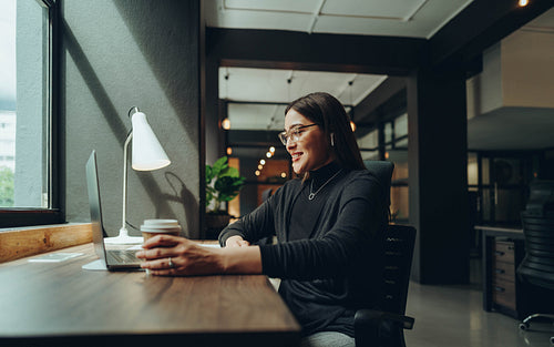 Happy businesswoman having an online meeting in the morning