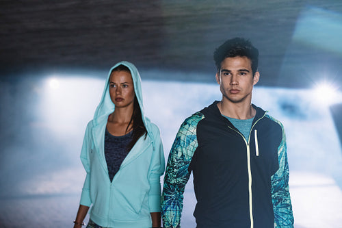 Fitness couple in city at night