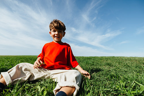 Boy enjoying carefree summer moment in open field