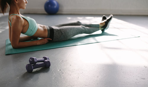 Fitness woman taking rest at gym after workout