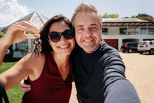 Selfie of a couple with keys of new home