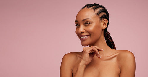 Pretty woman with glowing skin looking away