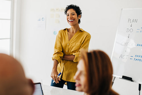 Female professional having a discussion with her team in an office