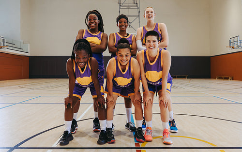 Champions together: Female basketball team poses proudly after victory