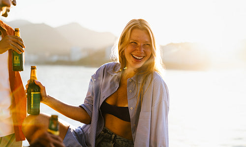 Friends enjoying drinks at sunset during a magical summertime evening