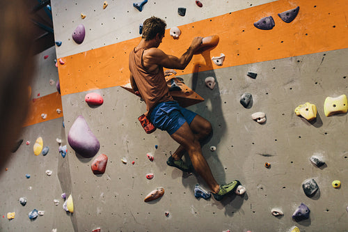 Man climbing indoor boulder wall