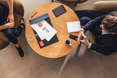 Business colleague sitting at table during corporate meeting