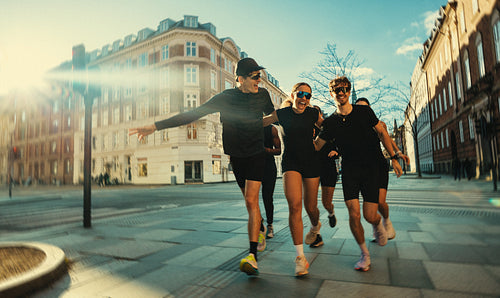 Sunny running with a group brings fitness culture to the city street
