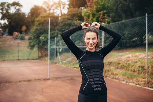 Sporty woman smiling outdoors